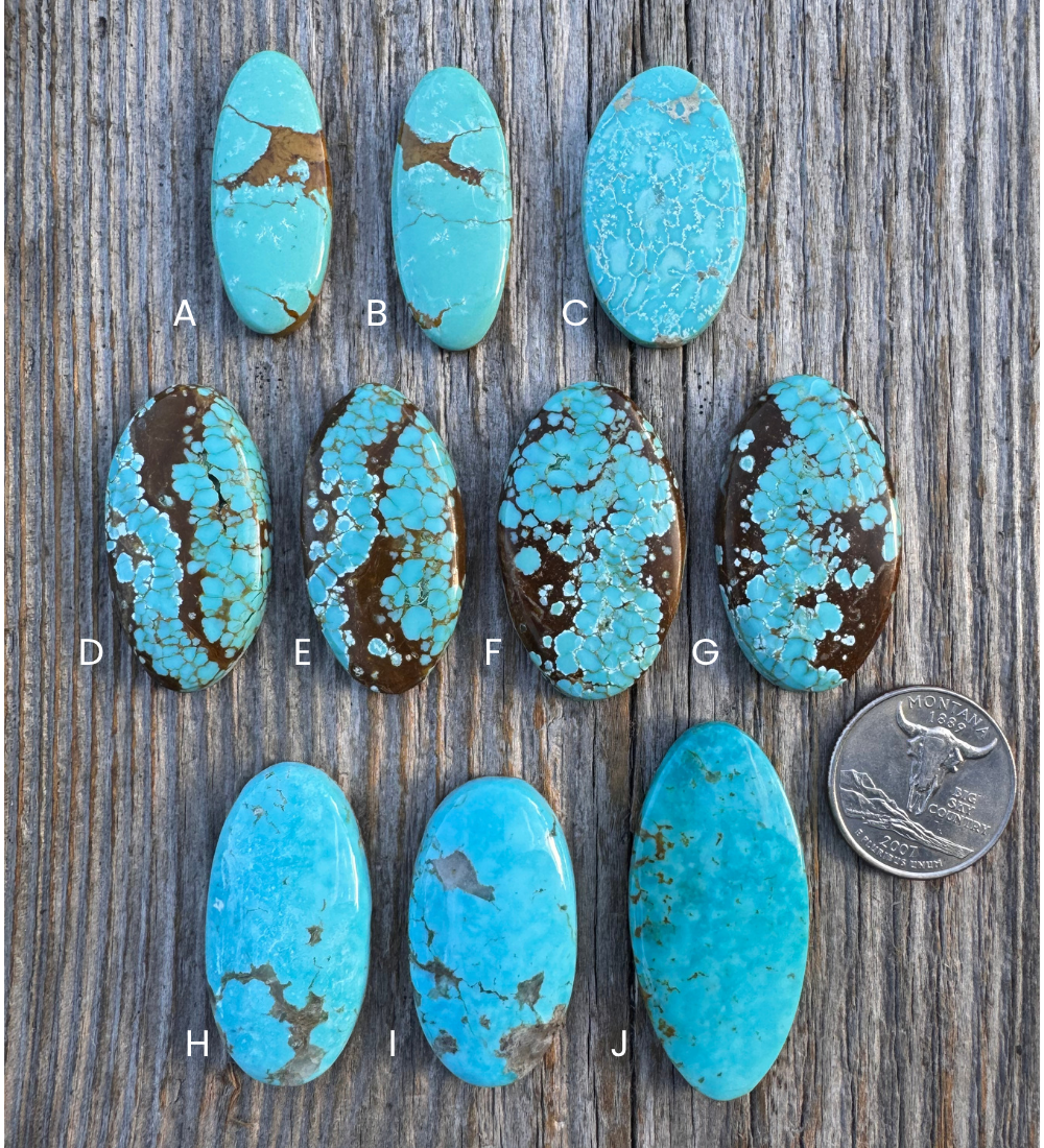 Turquoise stones labeled A to J on a wooden surface with a coin for scale.
