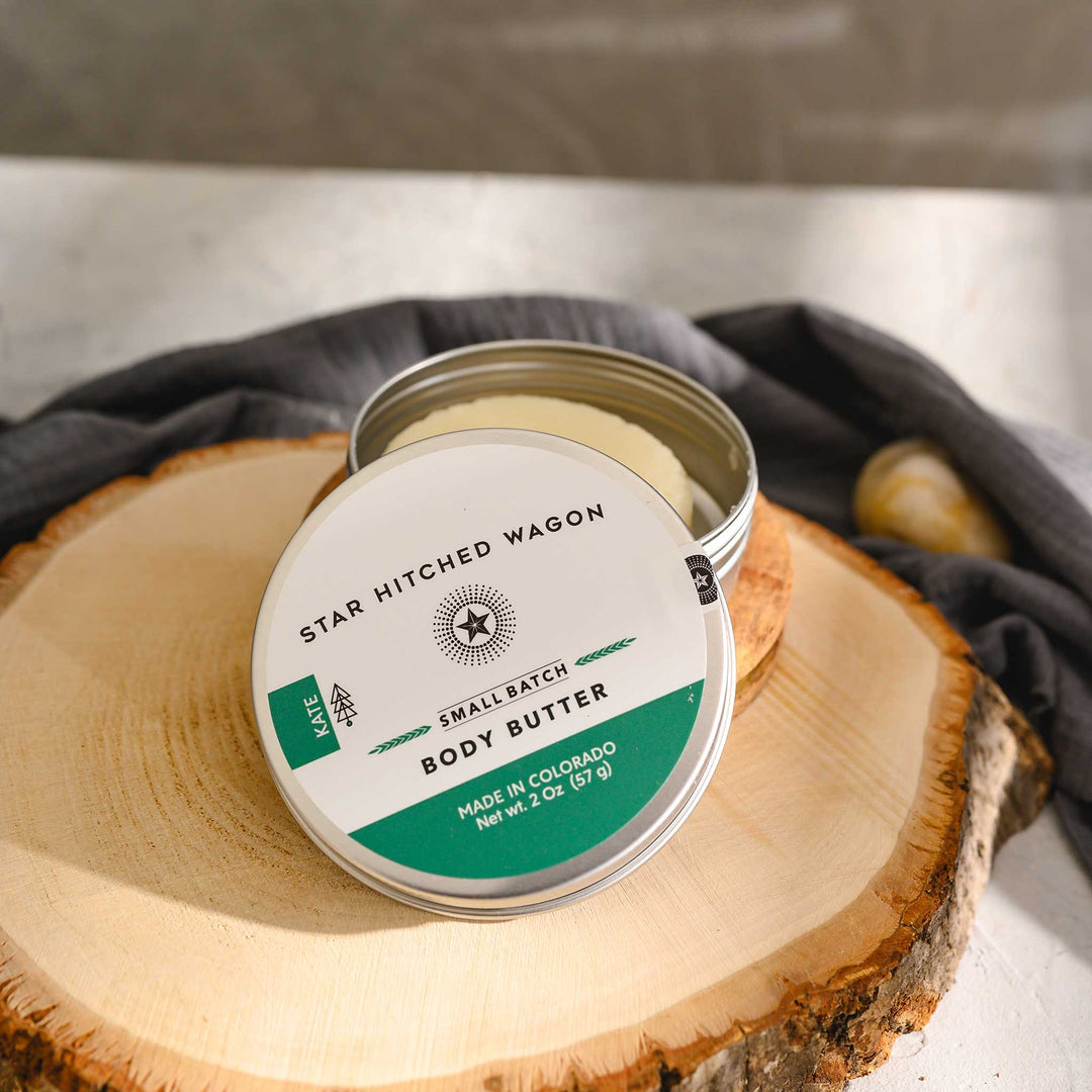 Kate body butter moisturizer in reusable tin, made with all natural oils and butters to soothe and protect dry skin. Forest-scented and handcrafted.