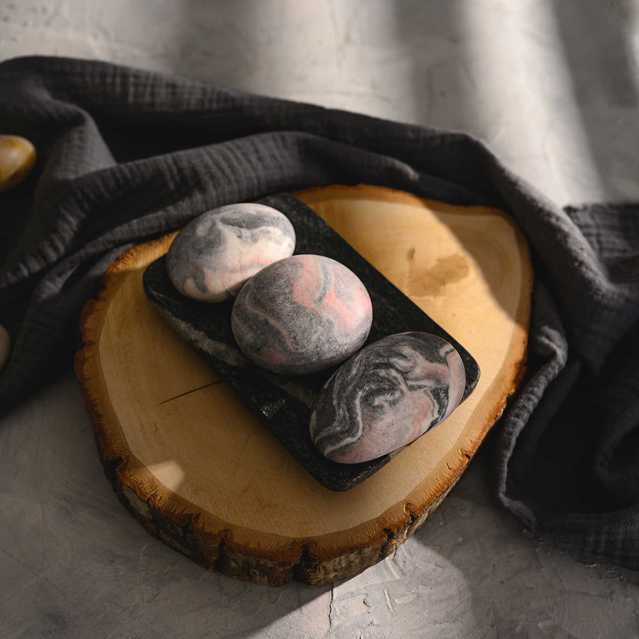 Margo River Stone Salt Soap Trio with black soap dish on wood slab.