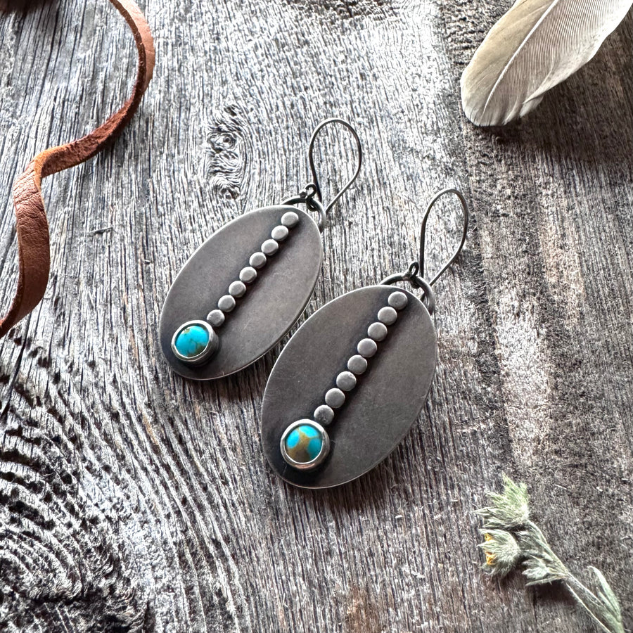 Sacred Path Large Turquoise Earrings on rustic wood with feather, dried flower and leather lace.
