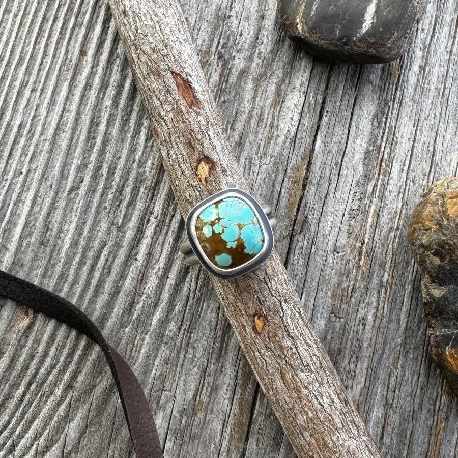 The Drift Ring — Chunky Turquoise Ring in Sterling Silver on a wooden surface
